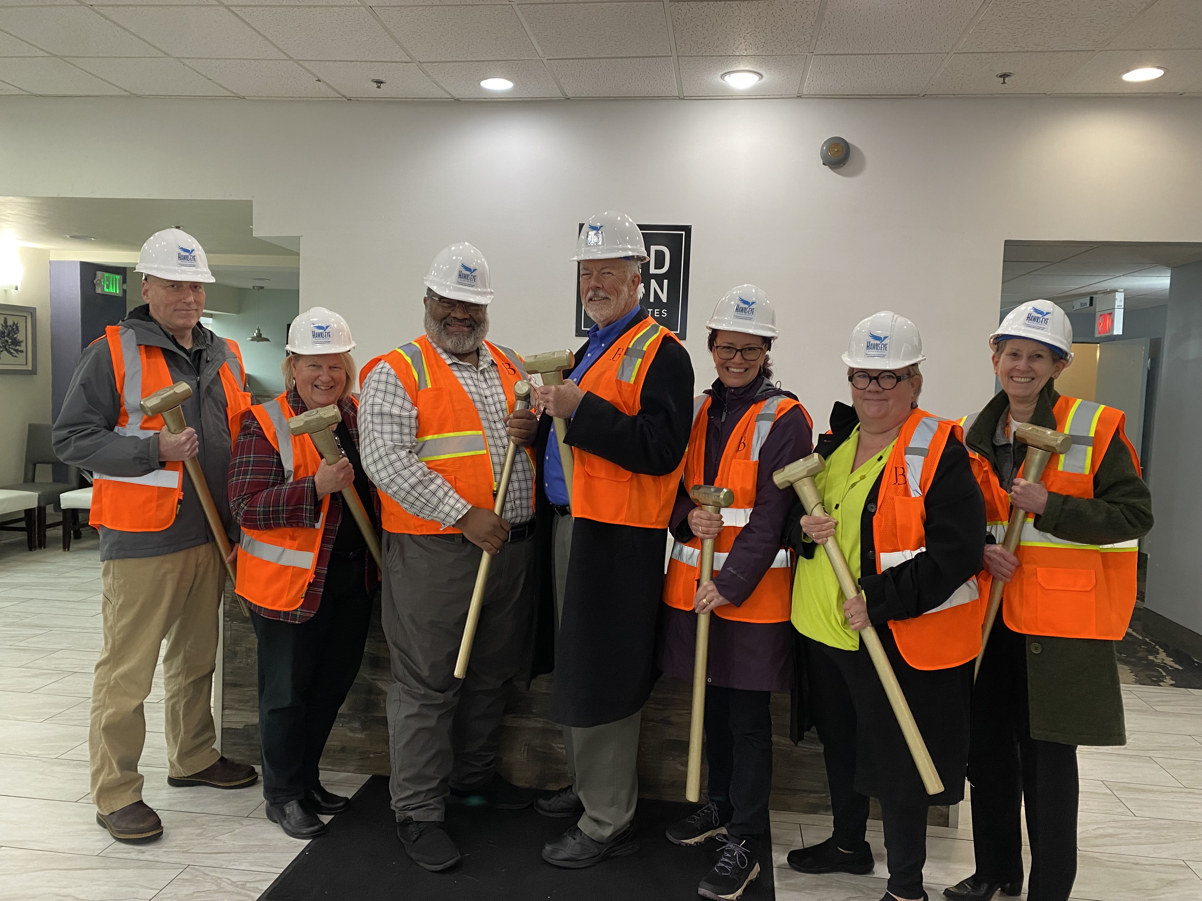 CareOregon, Columbia Pacific CCO, City of Seaside, Providence Hospital and Clatsop County Leaders Standing together holding gold sledgehammers.